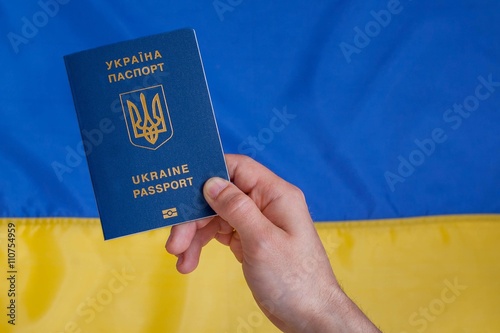 Passport on the background of the Ukrainian Flag