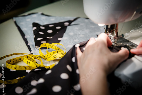 Sewing Process - Women's hands behind her sew