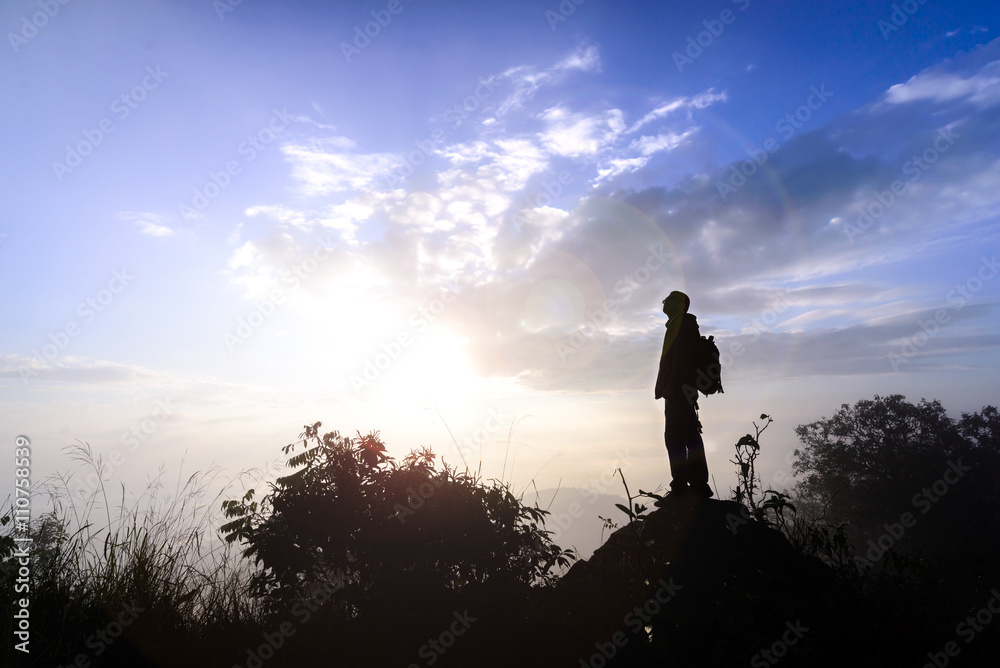 Silhouette man standing on mountain peak at sunrise. Silhouette man standing on mountain peak at sunrise.