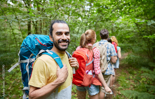 group of smiling friends with backpacks hiking © Syda Productions