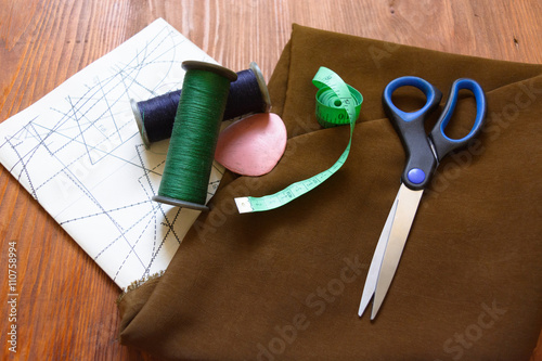 fabric, sartorial meter, scissors, chalk, threads, patterns, schemes