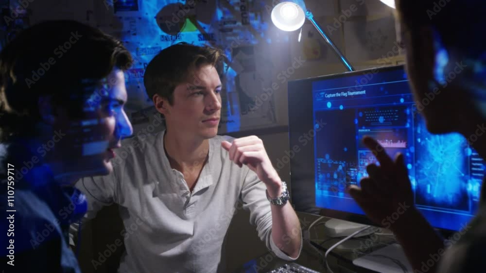  Young creative computer design team working together in dark office