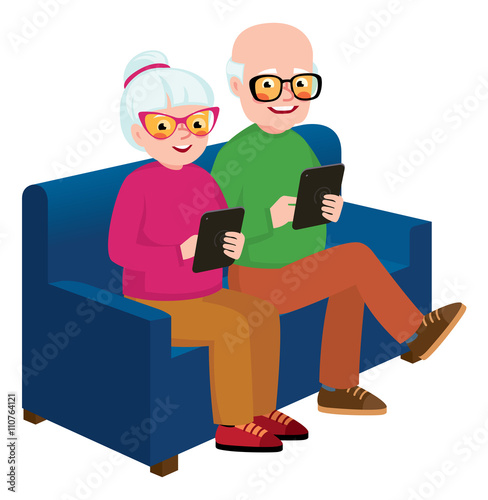 Senior couple husband and wife sitting on the couch with a compu