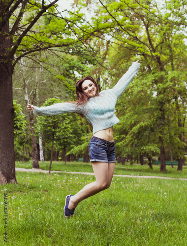 Happy teen girl having fun and jumping in summer  park © lkoimages