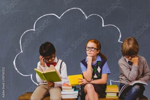 Obraz na plátně Composite image of schoolchildren reading and thinking