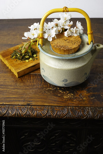 Japan's teapot with green tea and sakura flowers photo