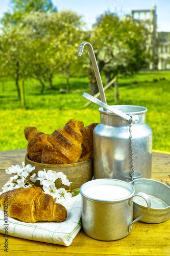 Aluminum milkcan witn organic milk and fresh baked croissants photo