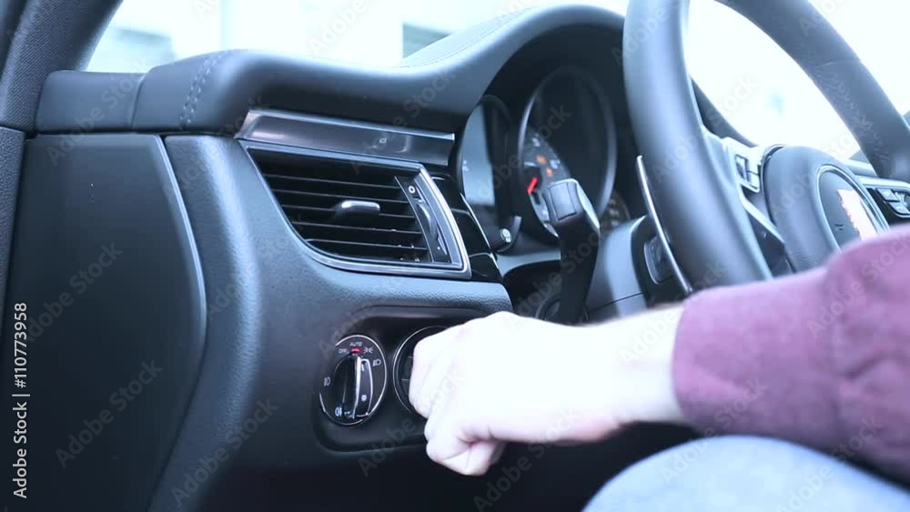 man starts the car with key. man starts the car with key.
