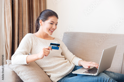 Woman buying online on laptop computer with credit card