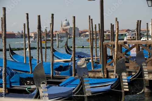 Gondolas moored at port in Venice, Italy. © devasite