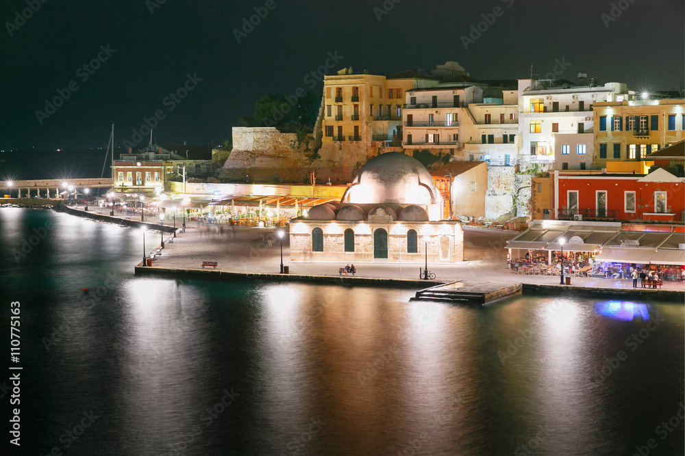 Picturesque view of Venetian quay of Chania with Kucuk Hasan Pasha Mosque at night, Crete, Greece