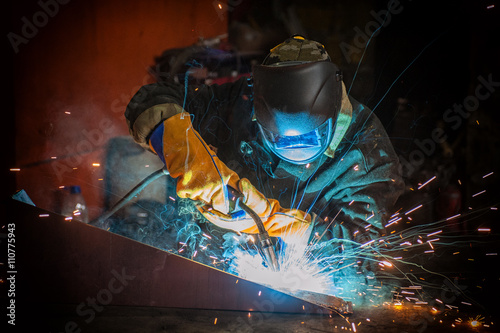 worker welding metal