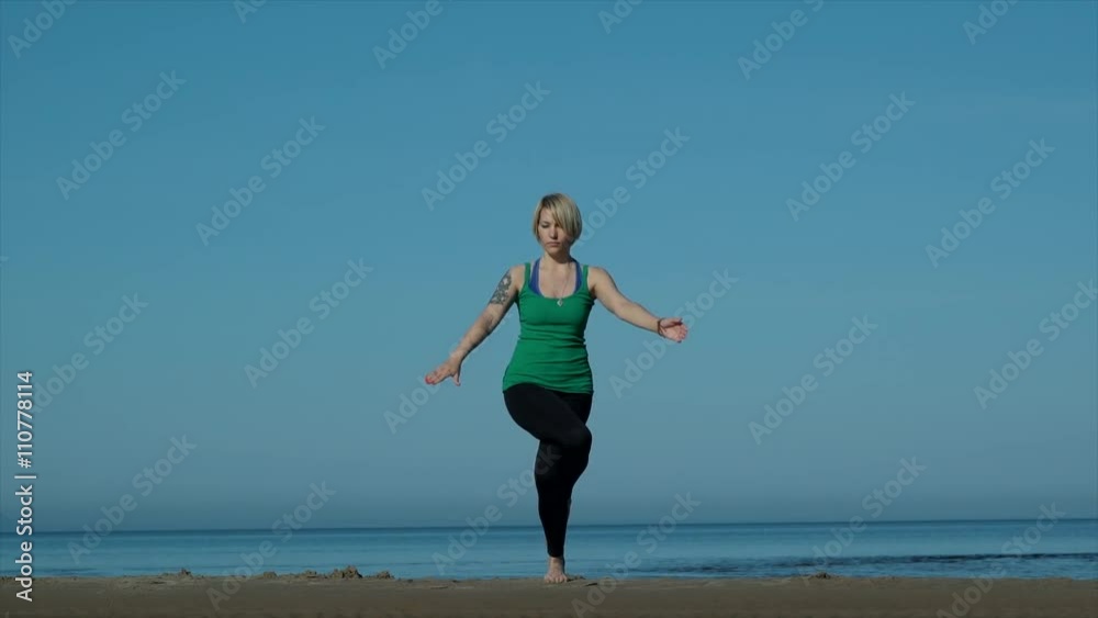 young pretty woman doing yoga on the beach in the afternoon young pretty woman doing yoga on the beach in the afternoon