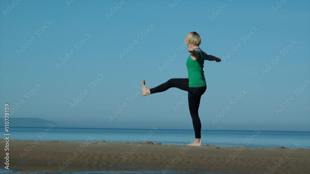 young pretty woman doing yoga on the beach in the afternoon young pretty woman doing yoga on the beach in the afternoon