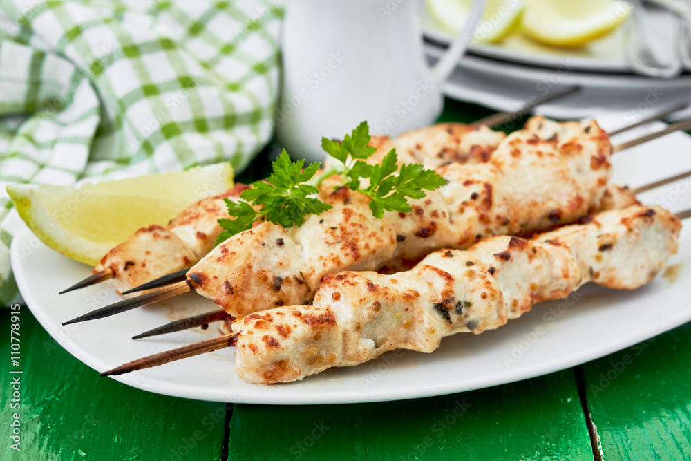 Chicken shish kebab on skewers with a lemon and parsley. horizontal