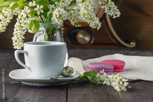 Kettle and cups with spring flowers photo