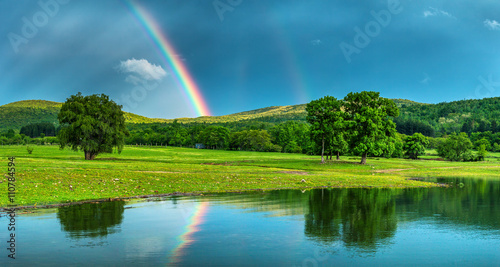 Rainbow over a lake, reflected in the water