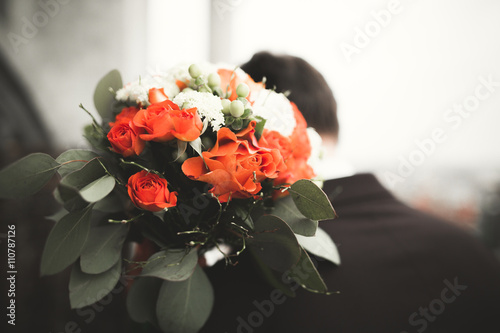 Fototapeta Naklejka Na Ścianę i Meble -  Pretty good wedding bouquet of various flowers in hand