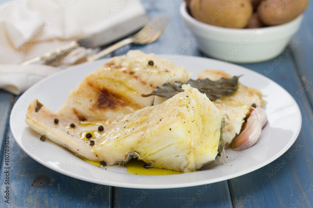 boiled cod fish with black pepper on white plate and boiled potato in bowl