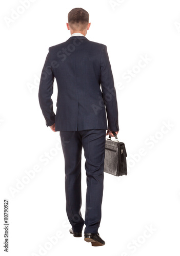 Businessman with briefcase walking away on white