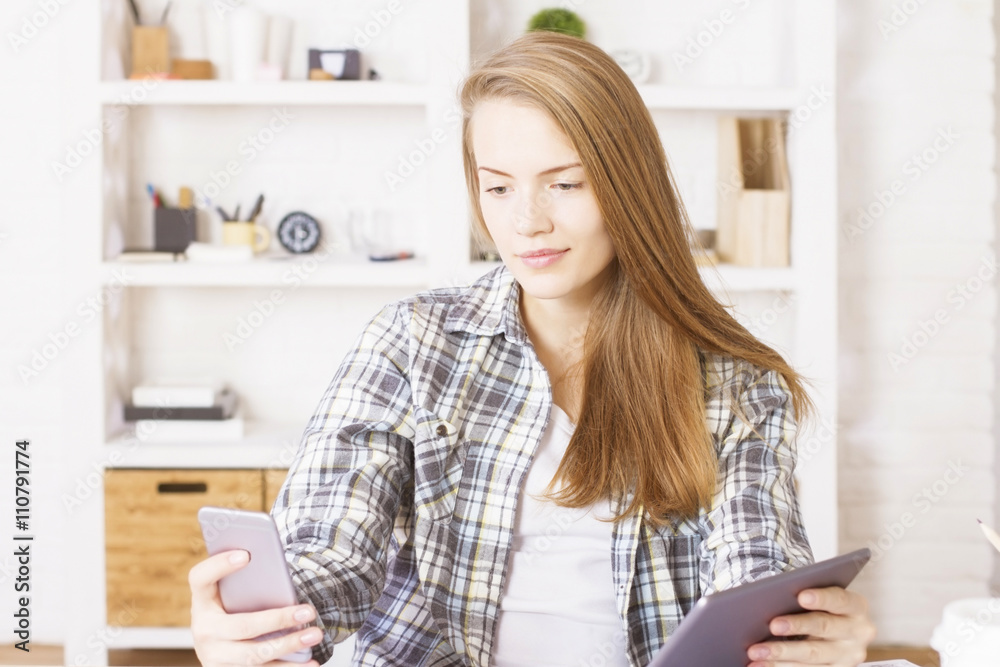 Female using smartphone and tablet Female using smartphone and tablet