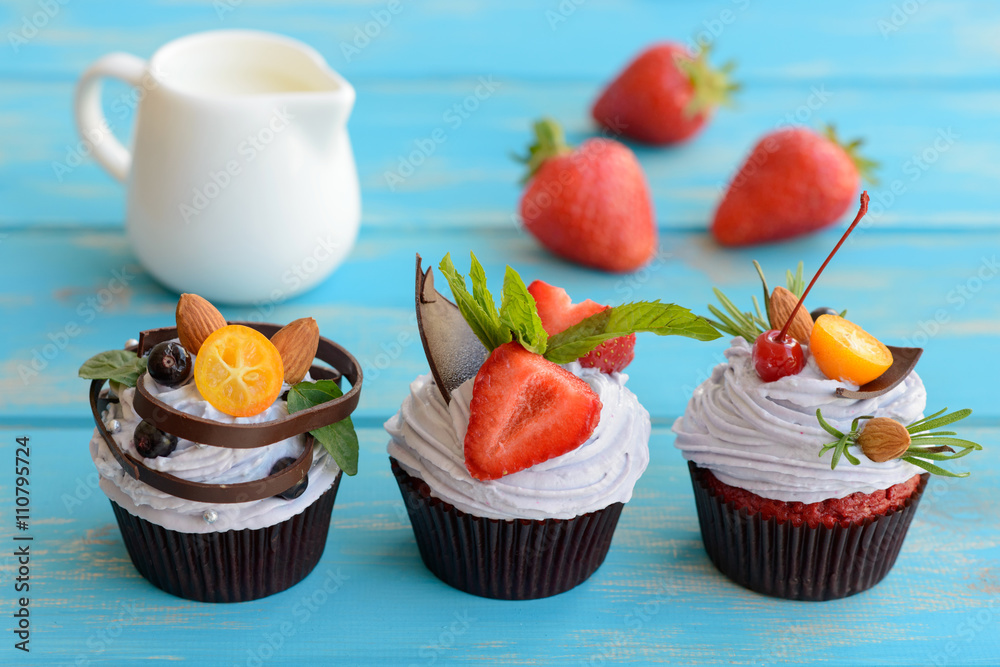 Tasty cake with pieces of fruit and strawberry on a table