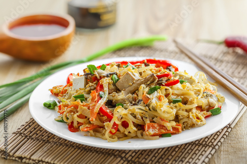 Stirred rice noodles with vegetables, tofu and shiitake mushroom. Traditional Asian food.