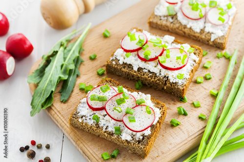 Ray bread with soft cream cheese and radish. Delicious vegetarian food.