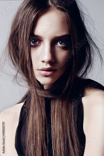 Beautiful young woman with long healthy brown hair and perfect skin