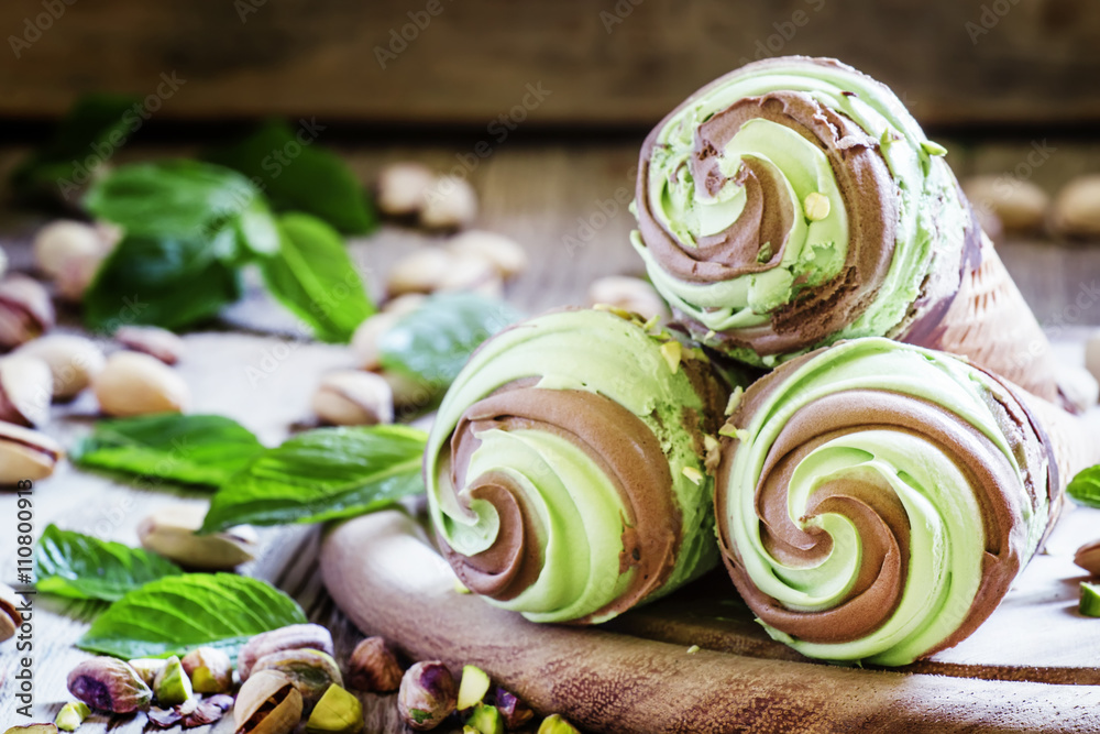 Green pistachio ice cream with chocolate and mint in cones, vint Green pistachio ice cream with chocolate and mint in cones, vint