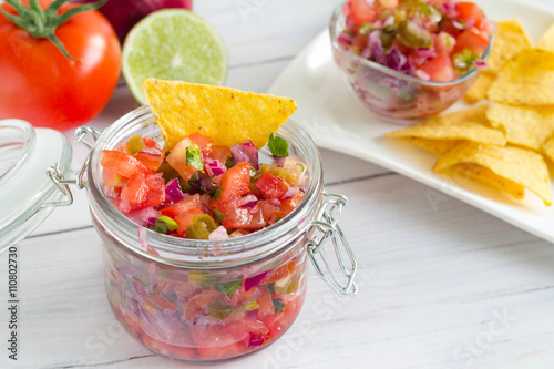 Fresh tomato salsa salad in a jar with tortilla chips