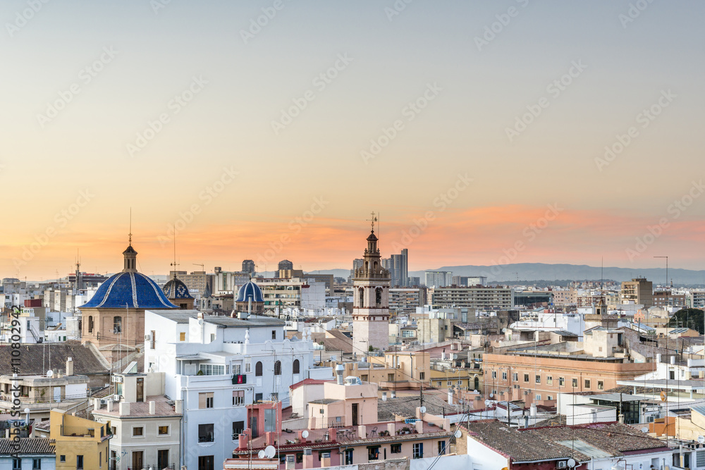 Panoramic view of the roofs of the ancient city of Valencia at sunset, Spain. The belfry of the Cathedral.