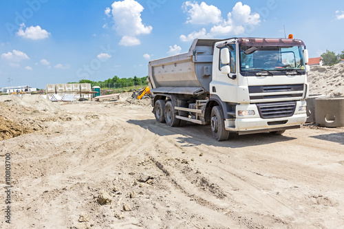 Фотография Big hydraulic dump truck is moving.
