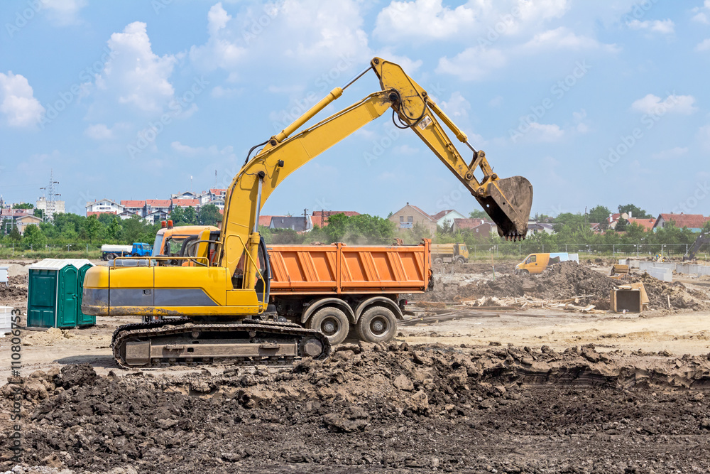 Excavator is working on construction site. Caterpillar in action Excavator is working on construction site. Caterpillar in action