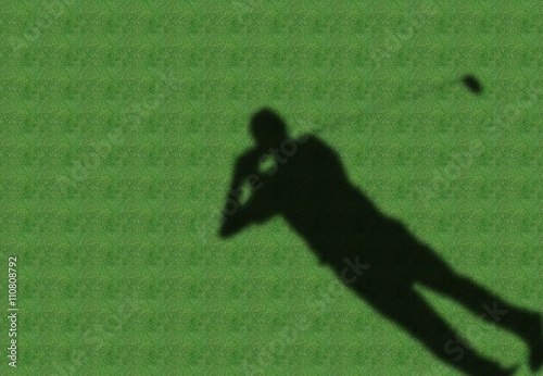 a shadow of golfer in a green fairway