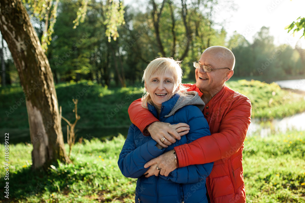 happy seniors couple embrace and smile;