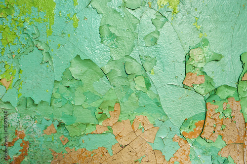 texture of the peeling green paint on a concrete wall