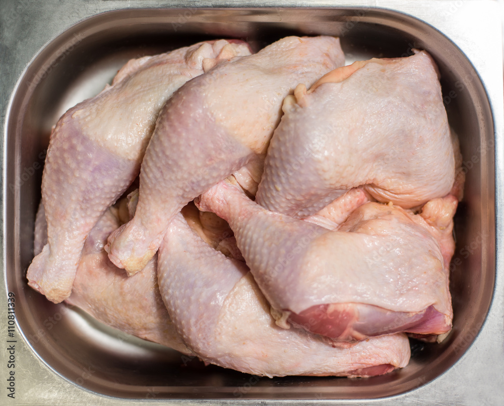 Raw chicken legs in an iron dish Raw chicken legs in an iron dish