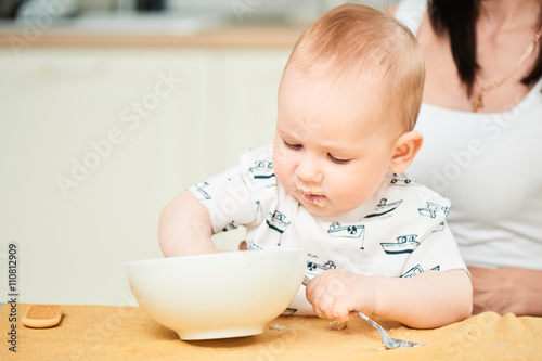 One-year-old boy learns to eat independently
