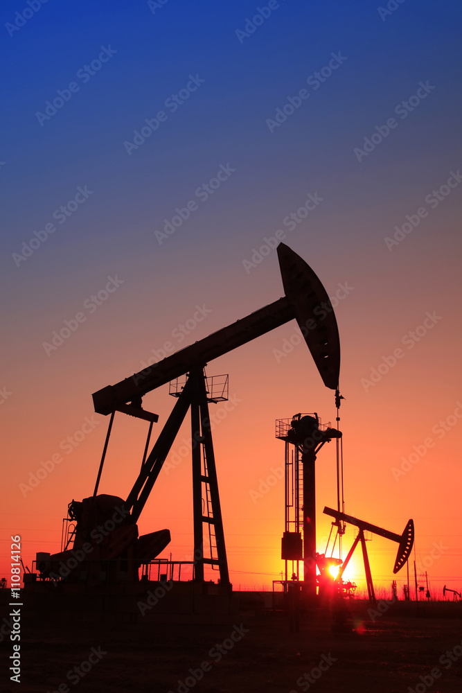 In the evening, the silhouette of the oil pump In the evening, the silhouette of the oil pump