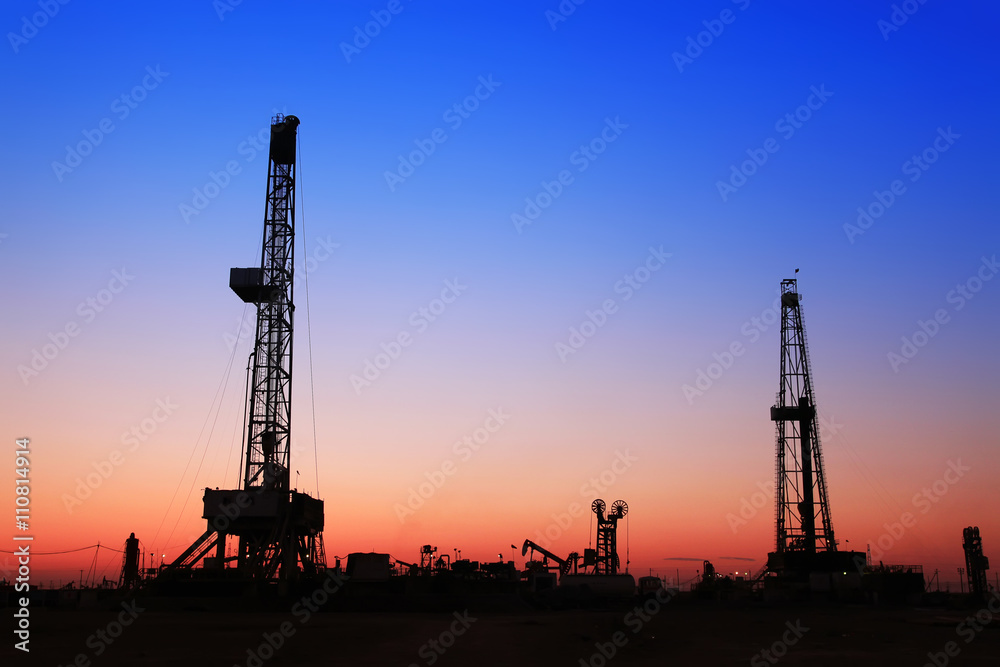 The silhouette of oilfield derrick
