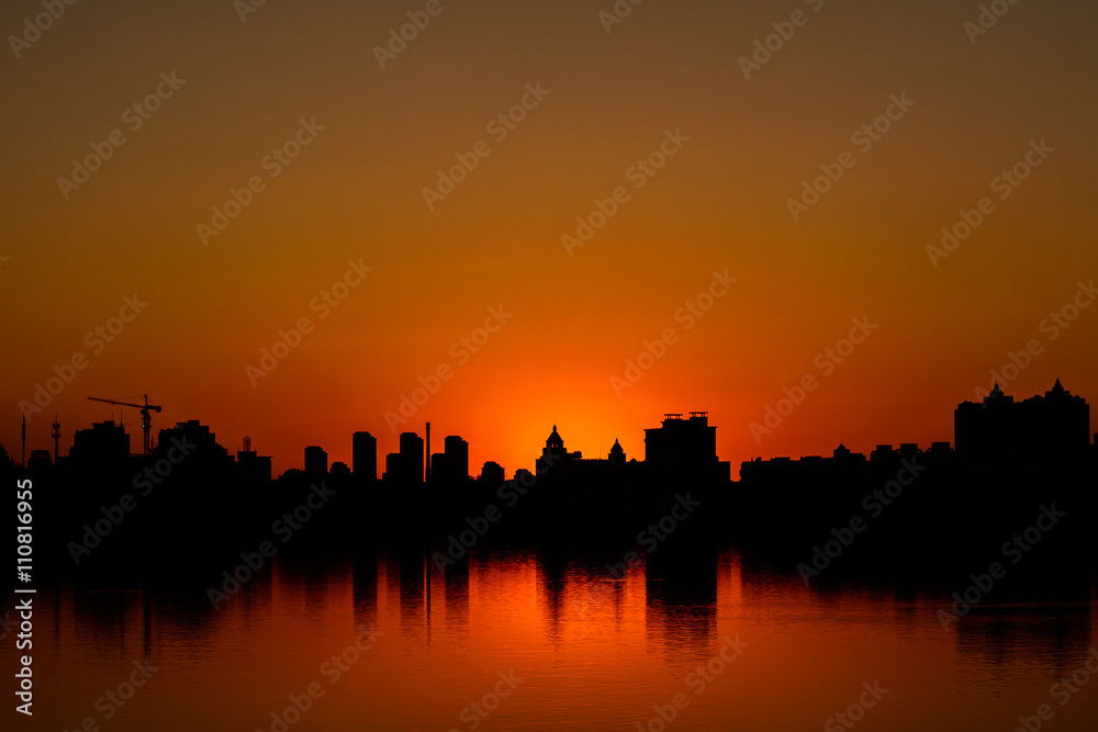 Silhouette of Buildings at sunset time in metro city.