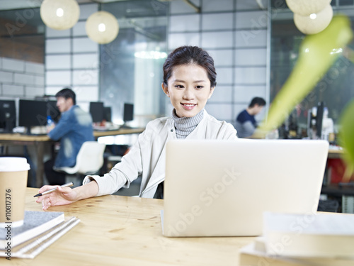 young asian business woman working using notebook computer in office