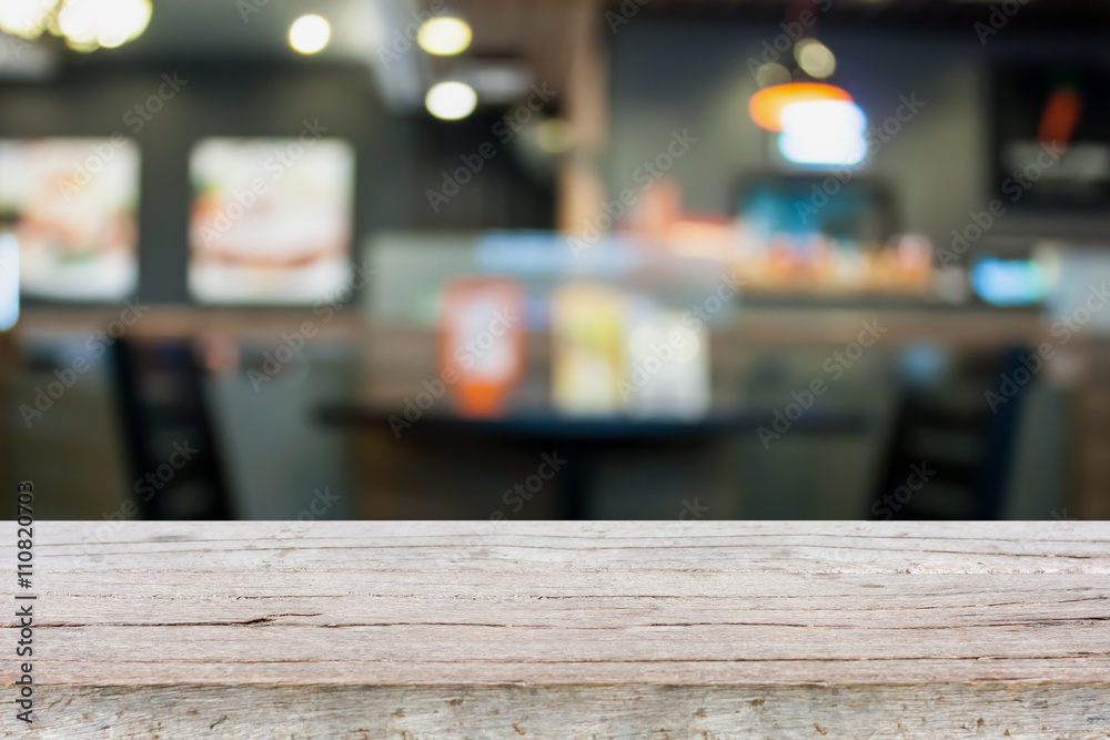 Empty wood table with cafe restaurant blur background with bokeh