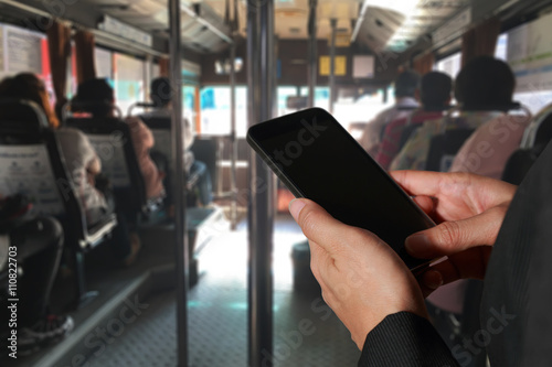Wallpaper Mural Woman hand hold and touch screen smart phone, tablet,cellphone on blurred abstract in the bus background as technology and travel concept. Torontodigital.ca