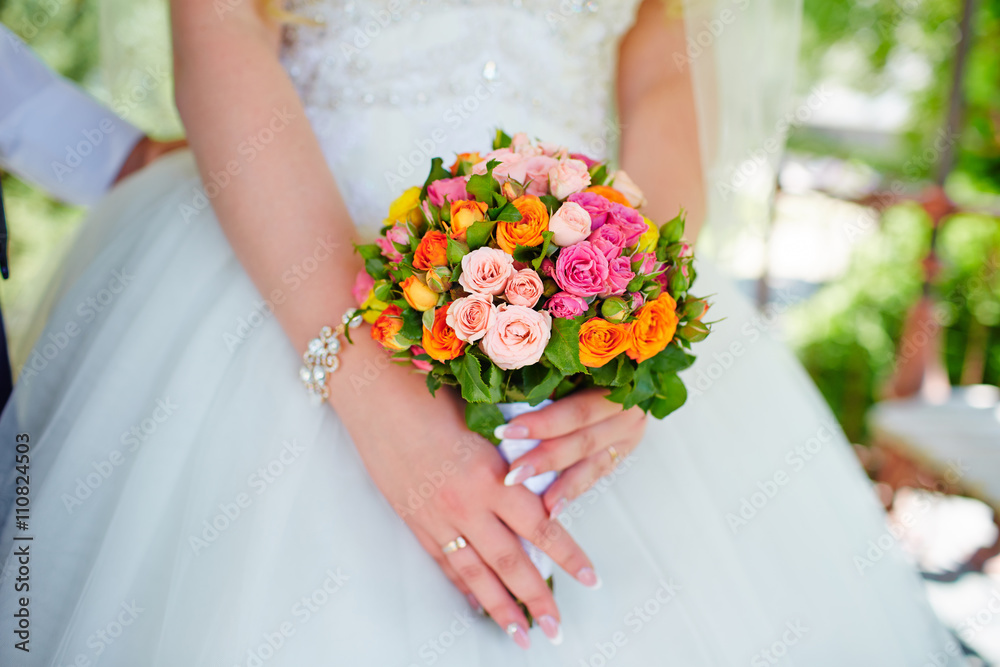 Wedding bouquet of roses in hands of the bride. Wedding bouquet of roses in hands of the bride.