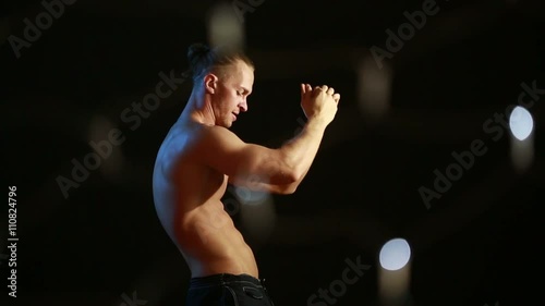 Muscular young sexy naked cute man. male striptease dancing. flashes of light and glare