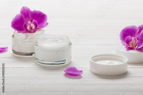 cream and pink orchid flowers on white wooden background