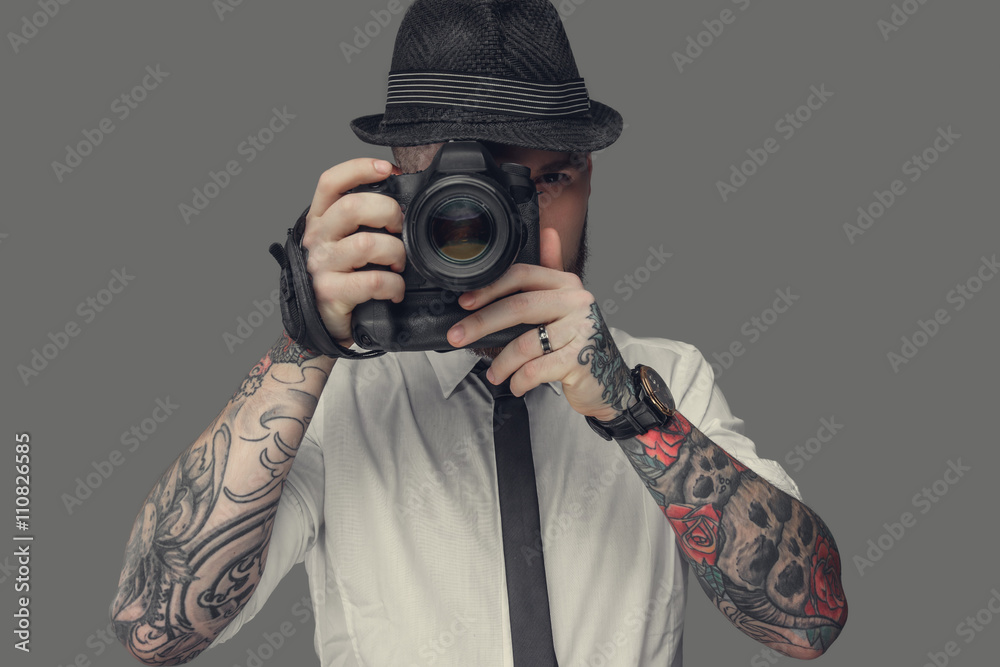 A man with dslr isolated on grey background. A man with dslr isolated on grey background.