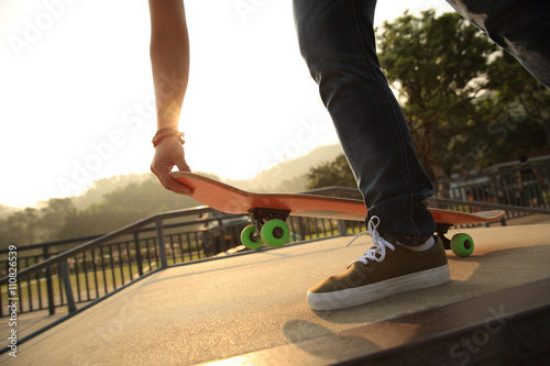 skateboarder skateboarding at skatepark ramp